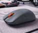 Gamer mouse with orange scroll wheel on gaming mouse pad.
